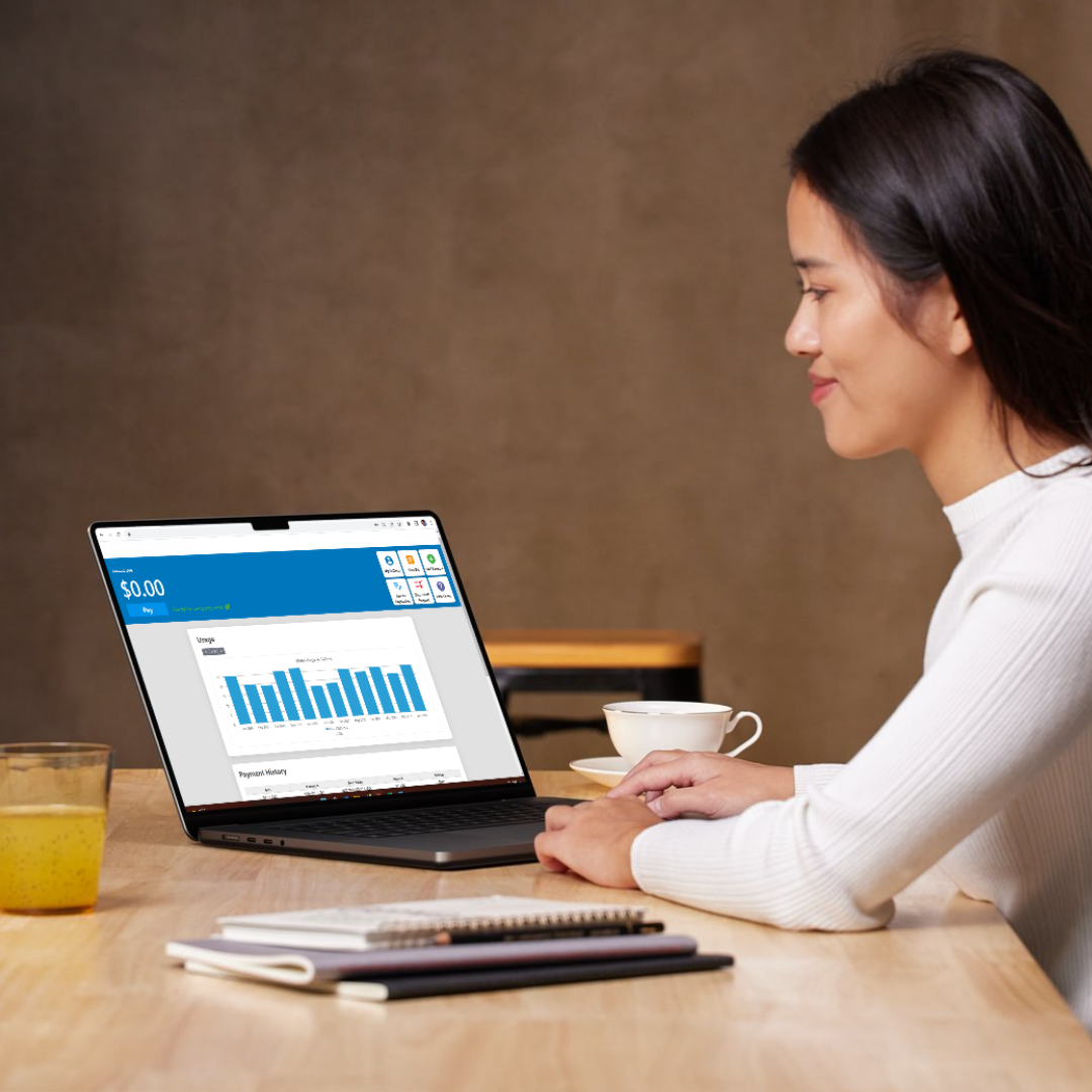 A woman at a desk using a laptop opened up her utility's customer web portal A woman at a desk using a laptop opened up her utility's customer web portal